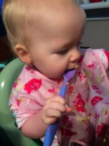 baby eating with a spoon