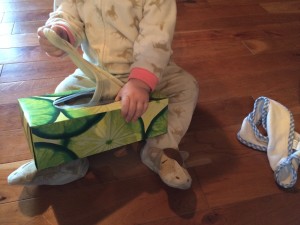 baby pulling fabric out of tissue box