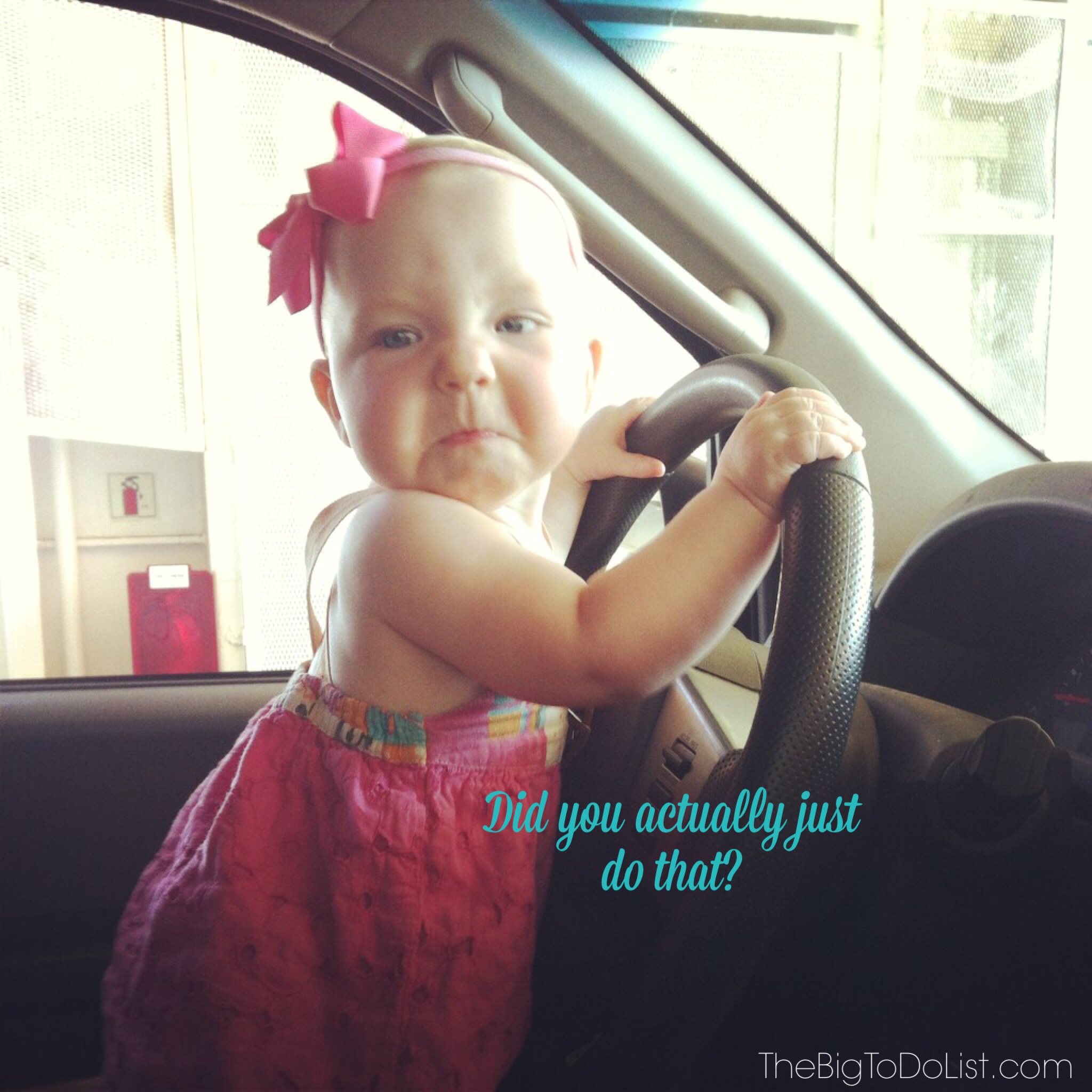 unimpressed baby at wheel