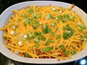 casserole topped with cheese and green onions