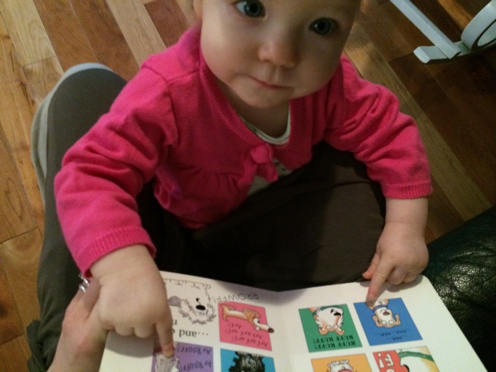 toddler pointing at book