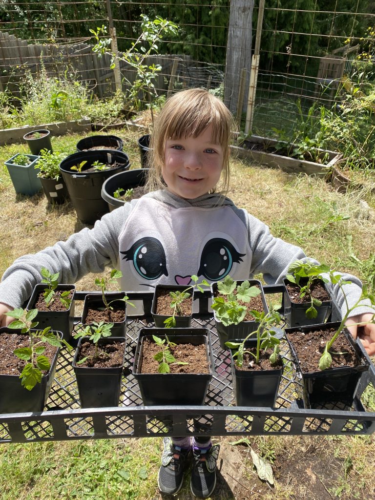 young entrepreneur with plant starts for her roadside stand