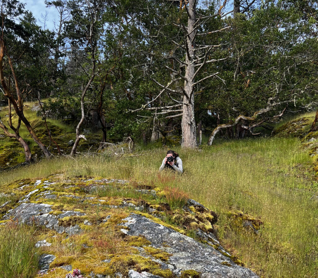 photographer hiding in grass behind scenes