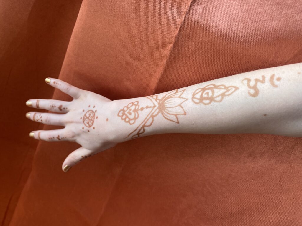 Henna decorating a hand and arm